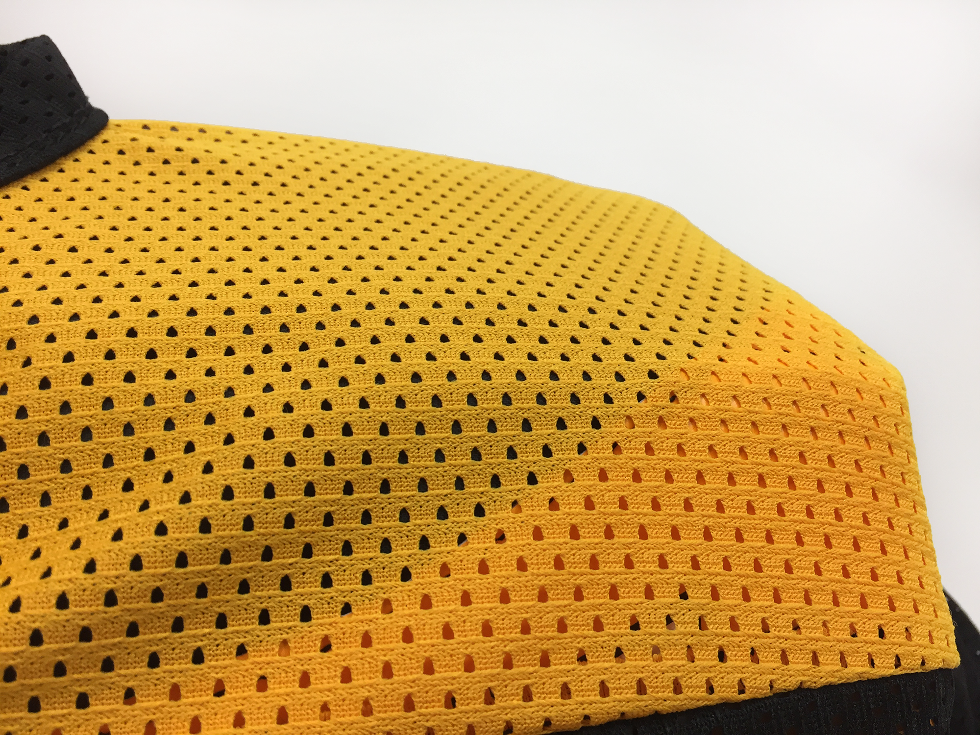 2400 jersey in black and sport gold close up of breathable mesh